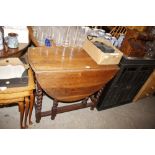 An early 20th Century oak gate leg dining table on
