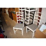 A set of six black and white painted ladder back d