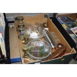A box containing two pairs of brass candlesticks,