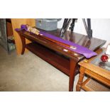 A reproduction mahogany two tier coffee table