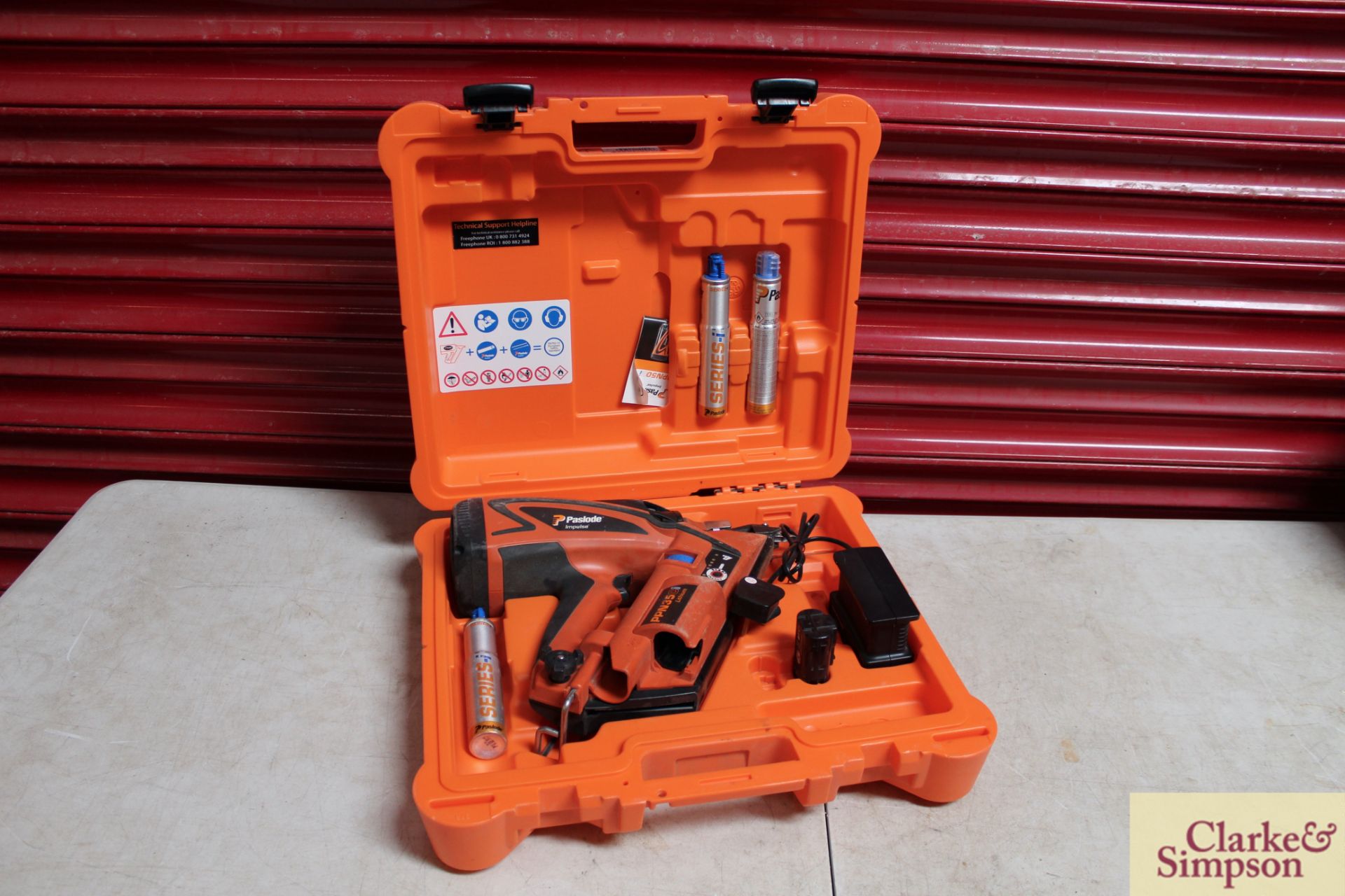 Paslode Impulse PPN35Ci Lithium nail gun with battery and charger in case.