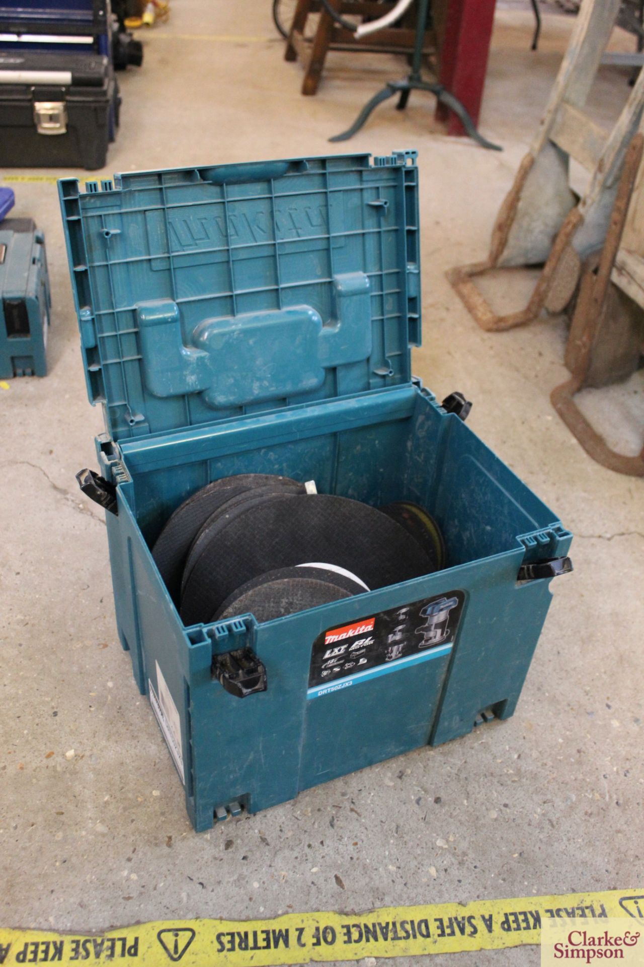Makita toolbox containing quantity of grinding and cutting discs.