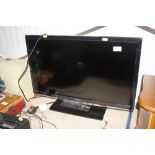 A Toshiba flat screen television with remote contr