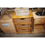 A pine and wicker work three drawer bedside chest