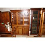 A reproduction mahogany bookcase, glazed upper sec