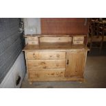 An antique stripped pine dresser base