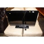 A Sony Bravia flat screen television with remote c