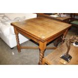 A 1930's light oak draw leaf dining table