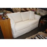 A modern cream three seater settee complete with l