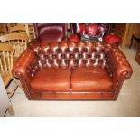 A deep buttoned leather upholstered Chesterfield s