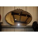 An oval gilt effect framed wall mirror