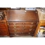 An antique oak bureau with fitted interior