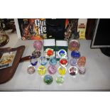 A quantity of various coloured glass paperweights