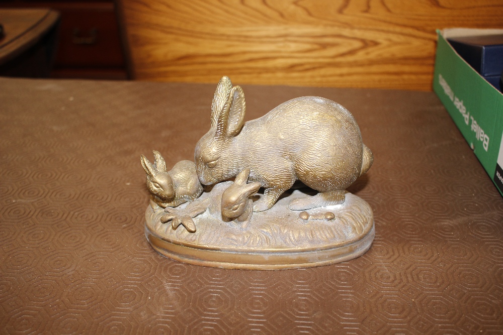 A gilt metal group of a rabbit and youngsters on a