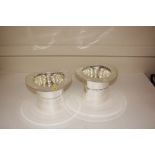 A pair of silver plated top hat wine coolers