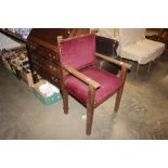 A 1930's oak elbow chair with upholstered seat and