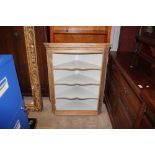 A stripped pine corner cabinet