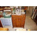 A walnut chest of five graduated drawers