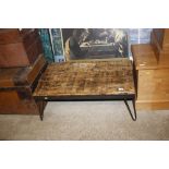 A wrought metal and reclaimed timber coffee table