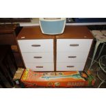 A pair of laminate three drawer bedside chests