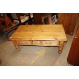 A large pine coffee table fitted two drawers