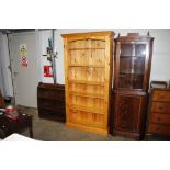 A set of stripped pine open fronted book shelves