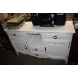 A painted dresser fitted cupboard and drawers