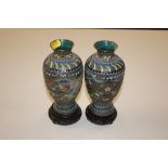 A pair of cloisonné vases and hardwood stands