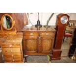 A mahogany side cabinet fitted two drawers and cup