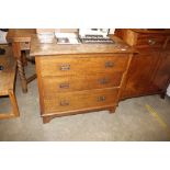 An Edwardian oak chest of three long drawers (conv