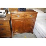 A mahogany side cabinet fitted two drawers and cup