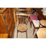 A pair of elm seated stick back kitchen chairs