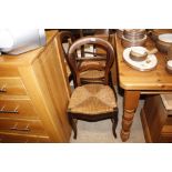 A set of four French fruitwood chairs with rush se