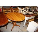 A circular pine kitchen table; and a pair of ladde