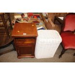 An oak bedside cupboard; and a wicker linen box