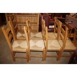 A set of seven pine ladder back and rush seated ki