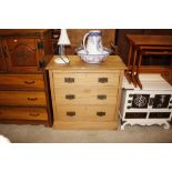 An Edwardian stripped satin walnut chest of three