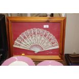 A framed and glazed fan