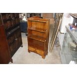 A walnut graduated bookcase fitted two drawers to