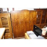 A 1930's walnut triple wardrobe