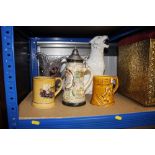 A glazed china figure of a leopard; a beer stein moulded glass jug; two mugs