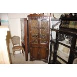 An oak leaded glazed corner cupboard