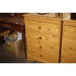 A pine effect chest fitted four long drawers