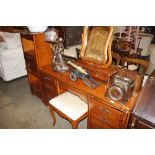 A modern polished wood pedestal dressing table wit