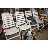 Four white plastic folding garden armchairs