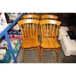 A set of four modern pine stick back kitchen chair