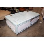 A painted under the bed blanket box on wheels