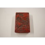 An oriental red lacquer box and cover