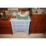 A blue painted chest of three long drawers