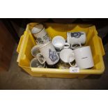 A box containing various mugs